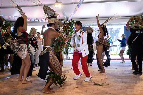 Chinese Surfer Yang Siqi dances during an opening ceremony